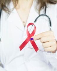 a woman in a white shirt holding a red ribbon