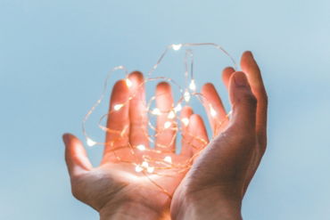 person holding string lights